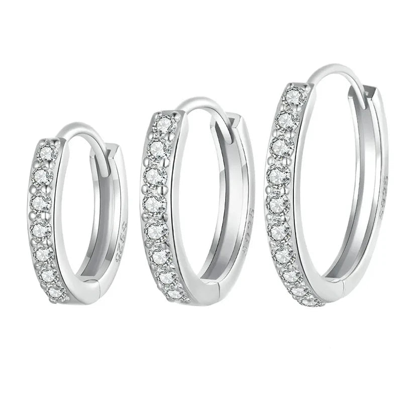 Sterling silver huggies style earrings set with cubic zirconia