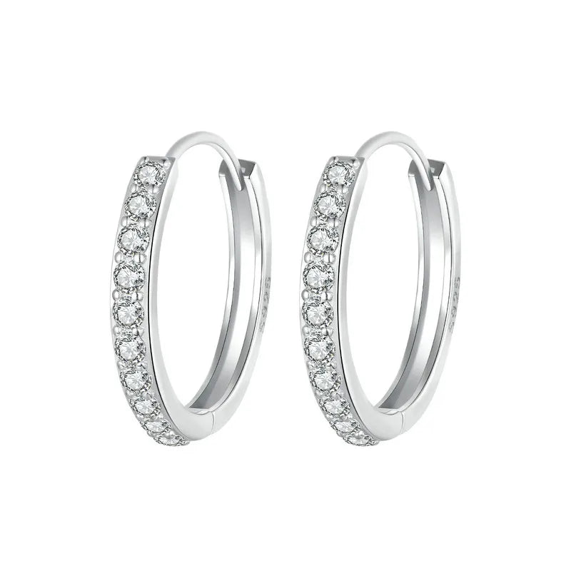 Sterling silver huggies style earrings set with cubic zirconia